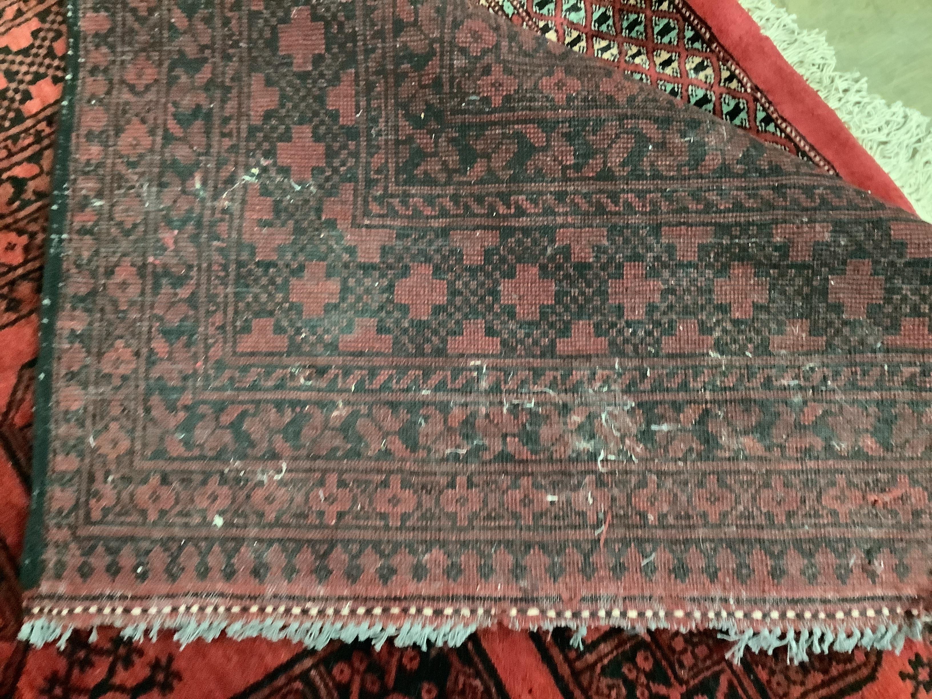 A Bokhara red ground carpet, 337 x 248cm